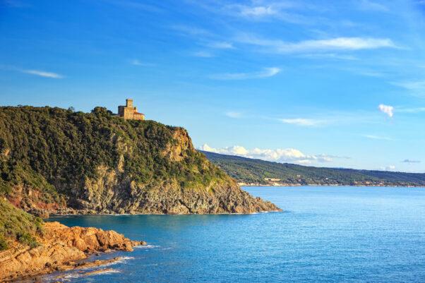 Cliff rock and building on the sea on sunset